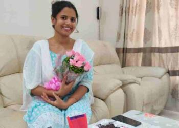 IAS Sanjita Mohapatra sitting on sofa