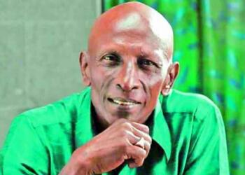 Motta Rajendran smiling in green dress