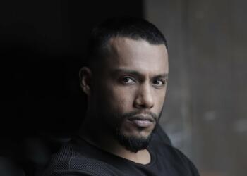 Dino James posing for photoshoot black and white