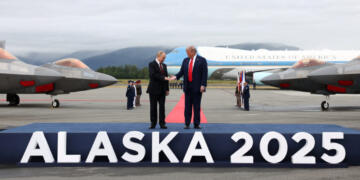 U.S. President Donald Trump goes to shake hands with Russian President Vladimir Putin, as they meet to negotiate for an end to the war in Ukraine, at Joint Base Elmendorf-Richardson in Anchorage, Alaska