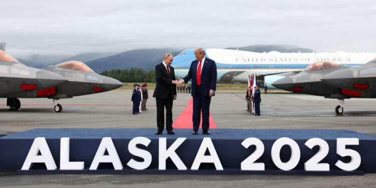 U.S. President Donald Trump goes to shake hands with Russian President Vladimir Putin, as they meet to negotiate for an end to the war in Ukraine, at Joint Base Elmendorf-Richardson in Anchorage, Alaska