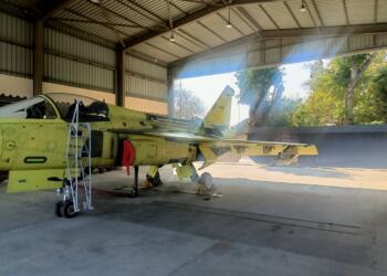 Tejas Mk1A light combat aircraft with tail number LA5051 inside a HAL hangar during final assembly.
