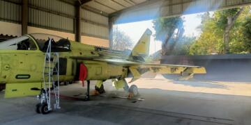 Tejas Mk1A light combat aircraft with tail number LA5051 inside a HAL hangar during final assembly.